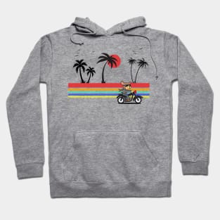 Dog riding a motorcycle along the beach with palm trees and a sunset Hoodie